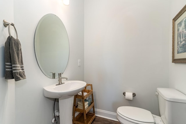 bathroom with sink, hardwood / wood-style flooring, and toilet