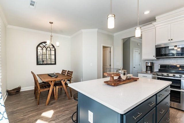 kitchen featuring white cabinetry, pendant lighting, stainless steel appliances, and a center island