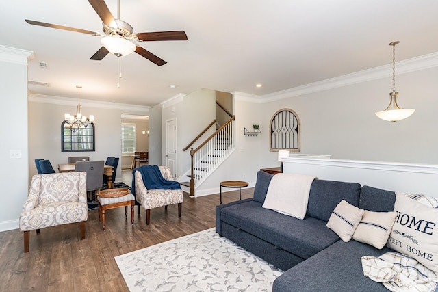 living room with dark hardwood / wood-style flooring, crown molding, and ceiling fan with notable chandelier