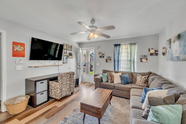 living room featuring light hardwood / wood-style flooring and ceiling fan