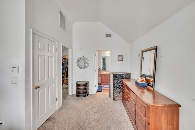 hall with light colored carpet and lofted ceiling