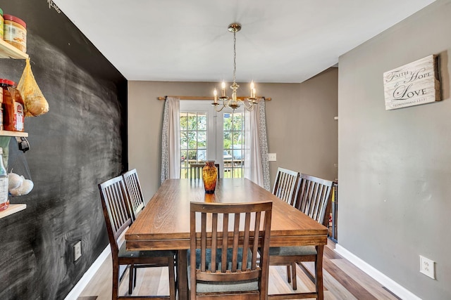 dining area featuring an inviting chandelier and wood-type flooring