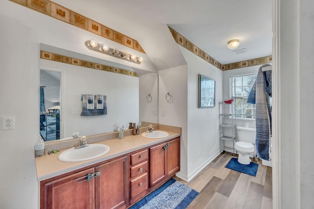 bathroom featuring hardwood / wood-style flooring, vanity, and toilet