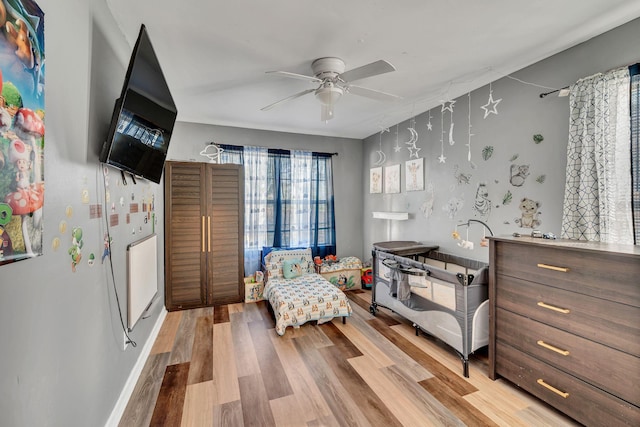 living area with ceiling fan and light hardwood / wood-style floors