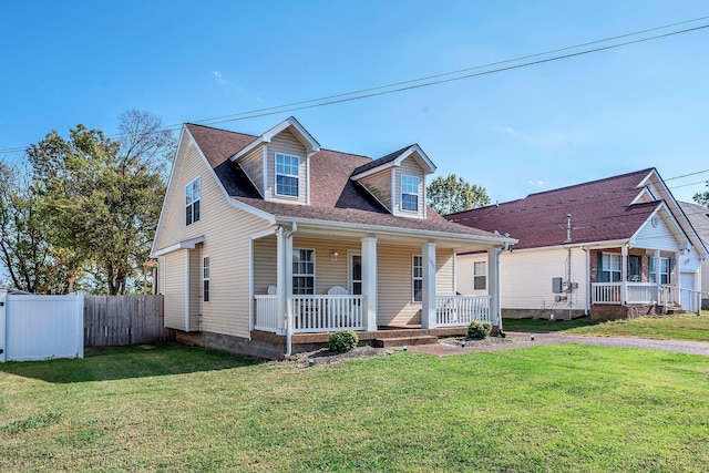 cape cod house with a front yard and a porch