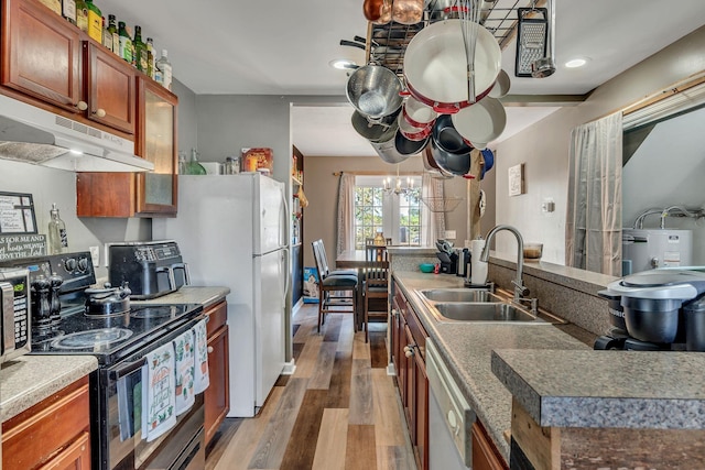 kitchen with hardwood / wood-style flooring, black electric range oven, sink, and dishwasher