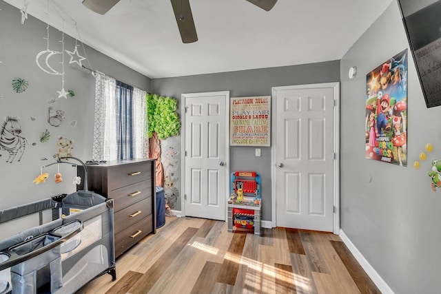 bedroom with ceiling fan and light hardwood / wood-style floors