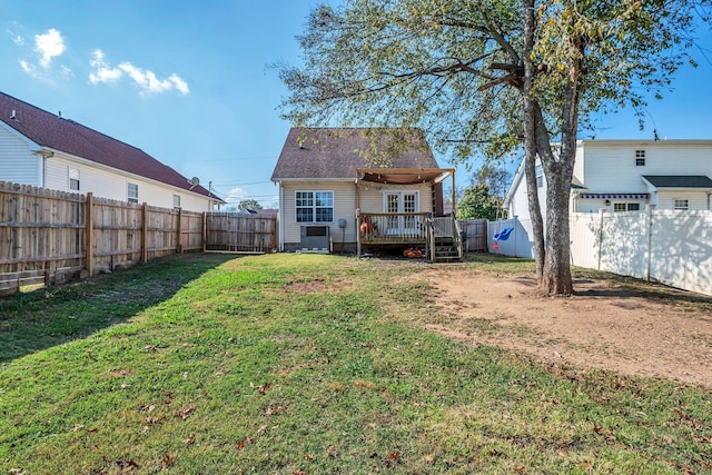 back of house featuring a deck and a lawn