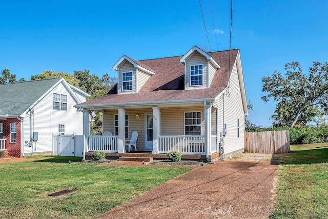 cape cod home featuring a porch and a front yard