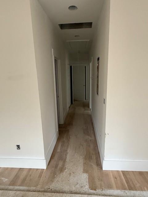 corridor with light wood-type flooring