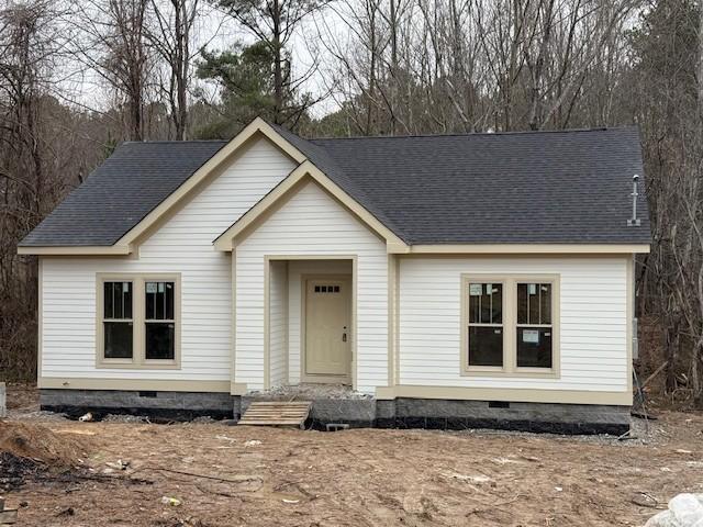 view of front of home featuring roof with shingles and crawl space