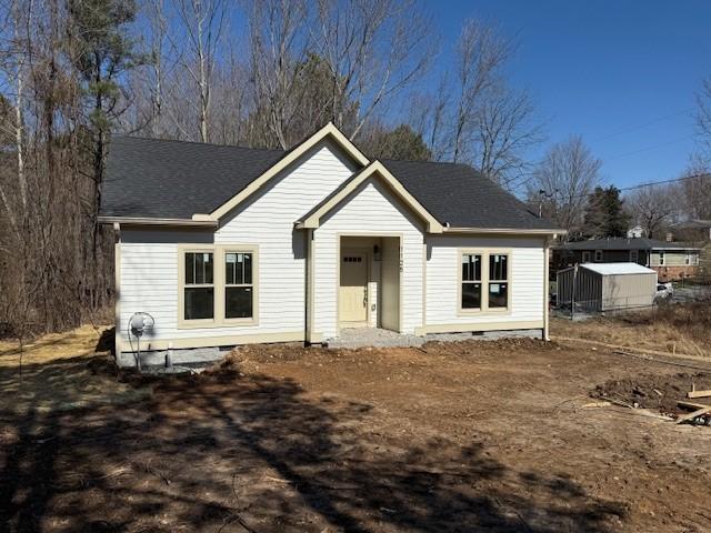 view of front facade with crawl space and a shingled roof