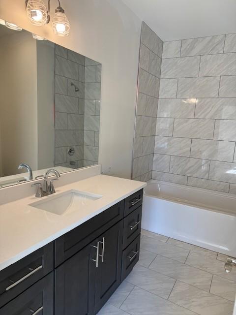 full bath with vanity and shower / bath combination