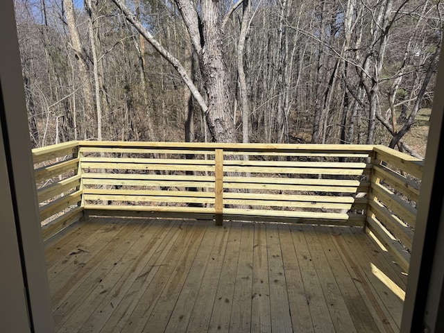 wooden deck featuring a wooded view