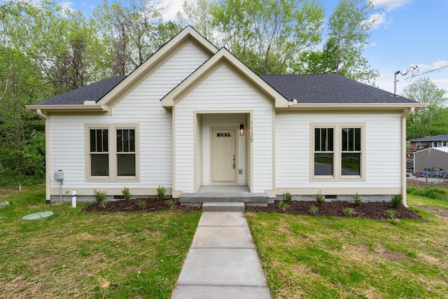 view of front of house with a front lawn, crawl space, and roof with shingles