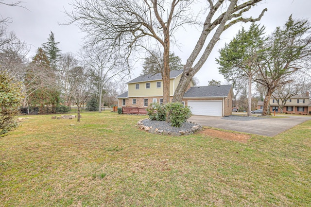 view of front of house with a garage and a front lawn