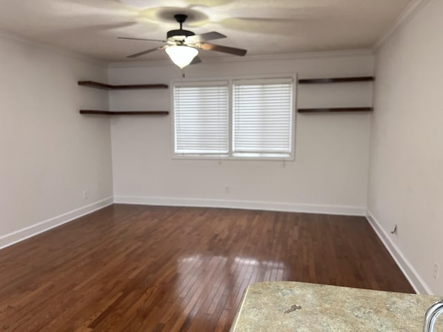 spare room featuring crown molding, ceiling fan, and dark hardwood / wood-style flooring