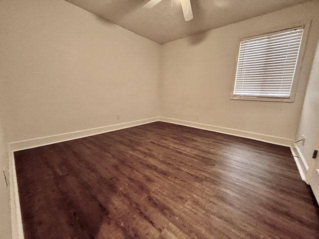 unfurnished room featuring dark wood-type flooring and ceiling fan