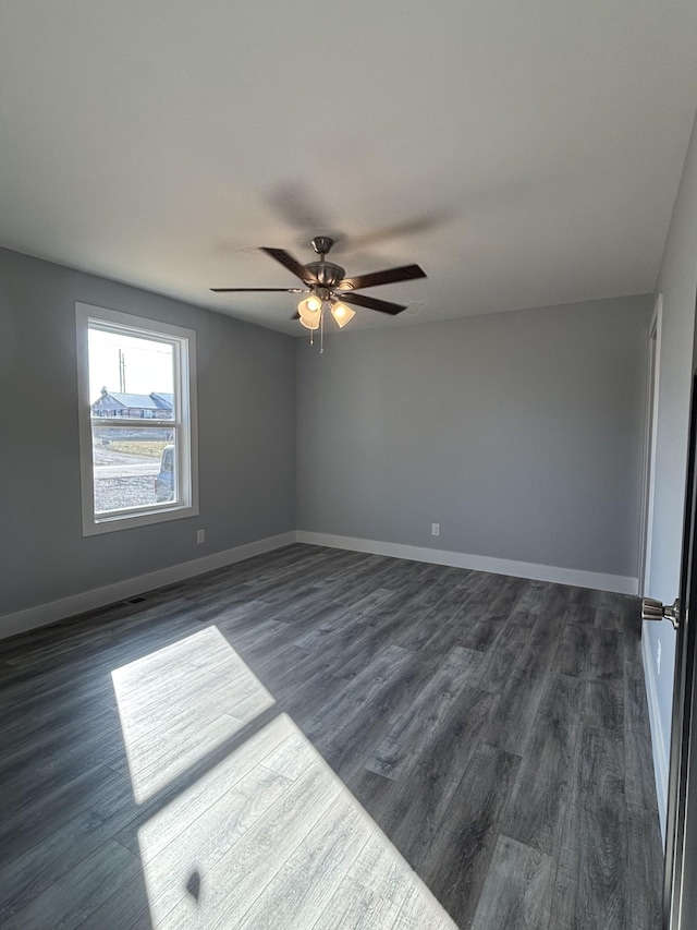 empty room with dark wood-type flooring and ceiling fan