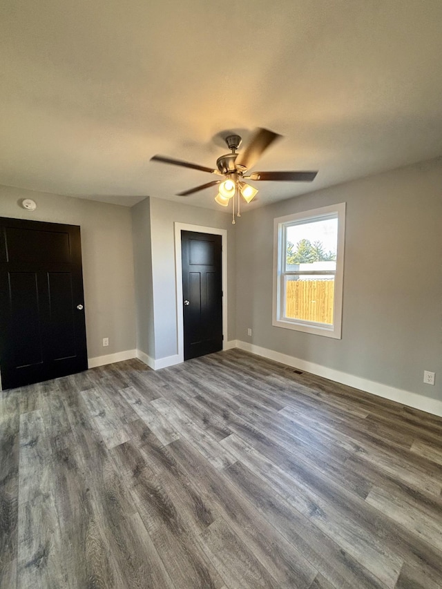 unfurnished bedroom featuring hardwood / wood-style flooring and ceiling fan