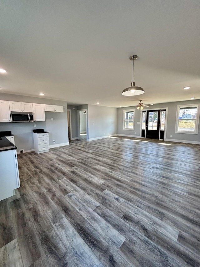 unfurnished living room with dark hardwood / wood-style flooring