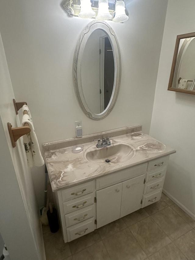 bathroom with a notable chandelier, vanity, and tile patterned floors