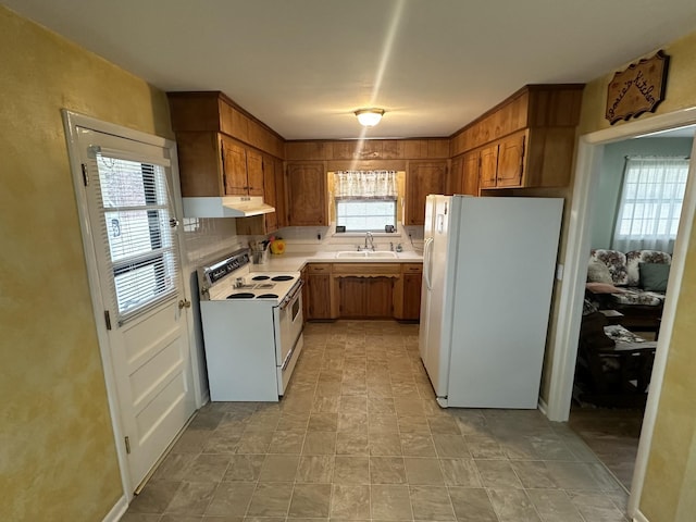 kitchen with sink and white appliances