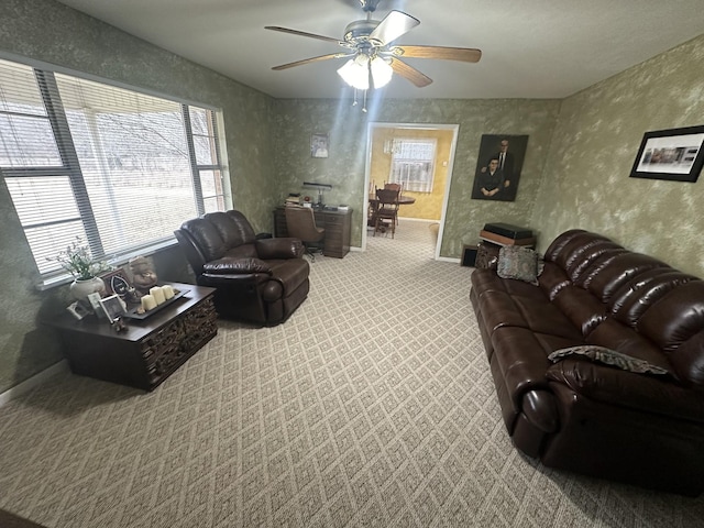 living room featuring carpet and ceiling fan