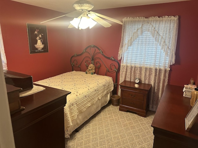 bedroom featuring light colored carpet and ceiling fan