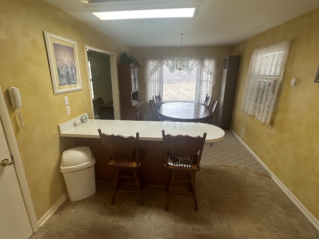 dining space featuring a notable chandelier