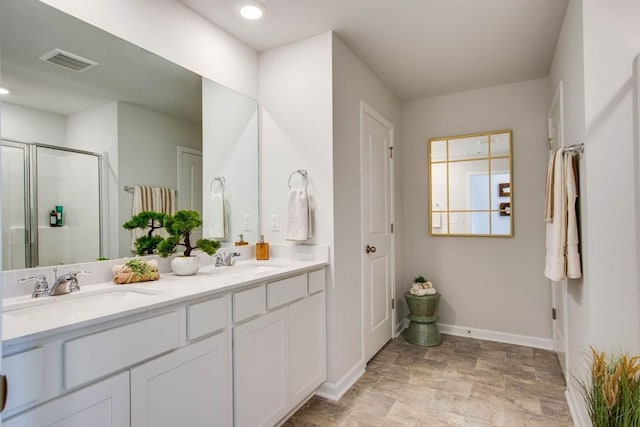 bathroom featuring vanity and a shower with shower door