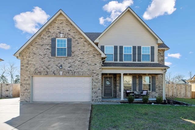 view of front of house with a porch, a garage, and a front yard