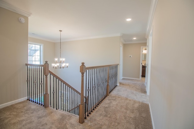 hallway featuring crown molding, light colored carpet, and an inviting chandelier