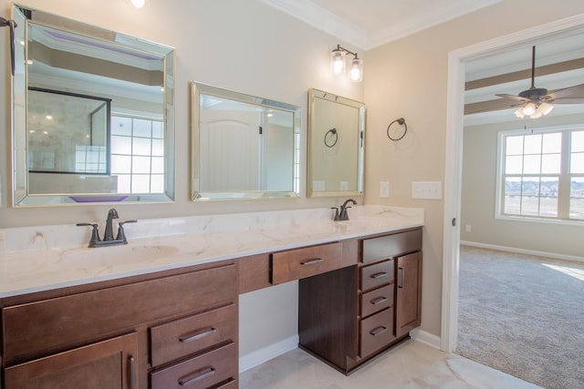 bathroom featuring ceiling fan, ornamental molding, and vanity