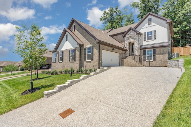 view of front of home featuring a garage, central air condition unit, and a front lawn