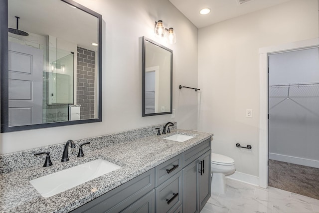 full bathroom with a stall shower, baseboards, marble finish floor, and a sink