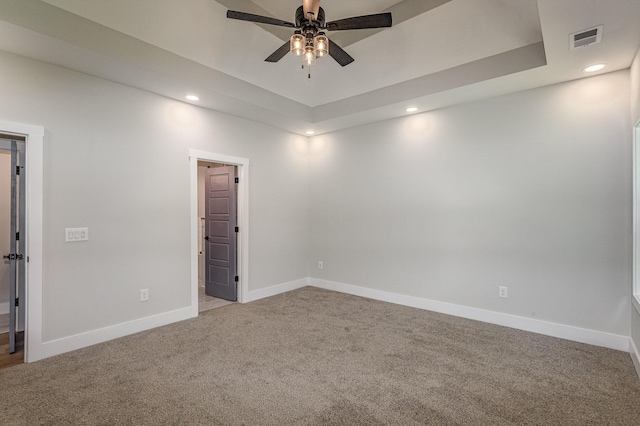 spare room featuring light carpet, recessed lighting, visible vents, and baseboards