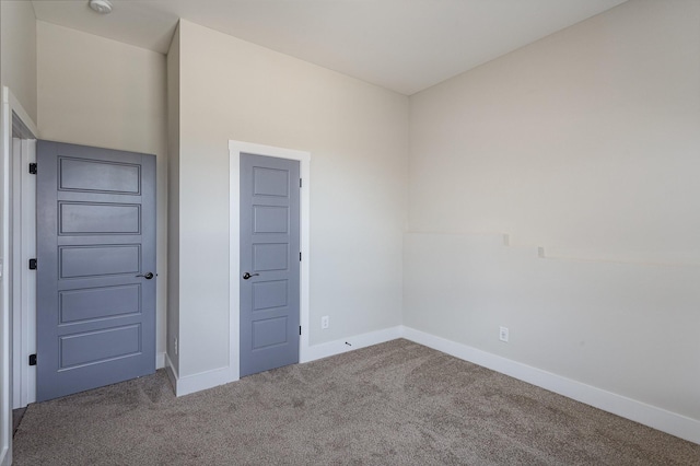 unfurnished bedroom featuring carpet flooring and baseboards