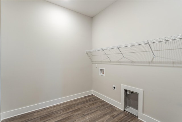 laundry area featuring hookup for a washing machine, laundry area, dark wood-type flooring, baseboards, and electric dryer hookup