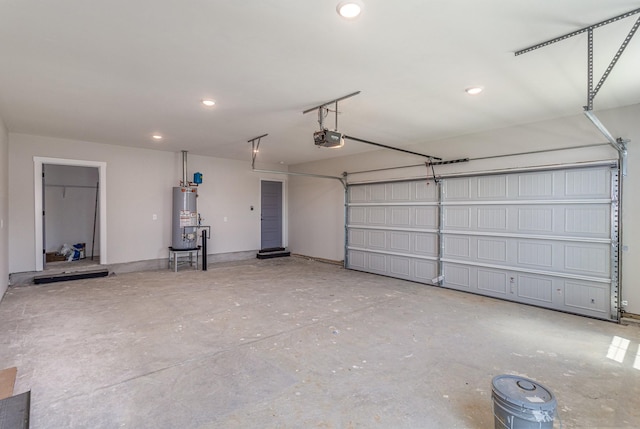 garage featuring a garage door opener, recessed lighting, and water heater