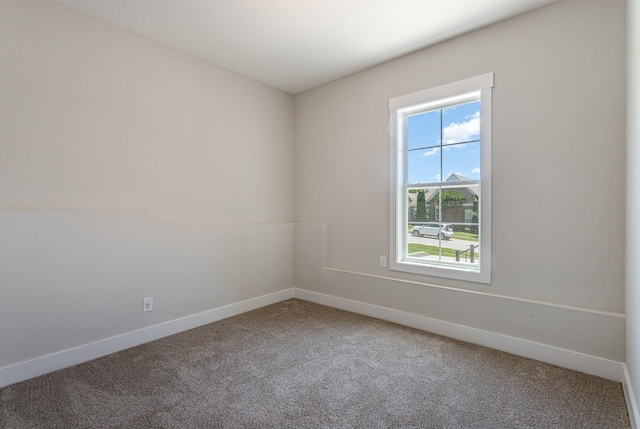 carpeted spare room with baseboards