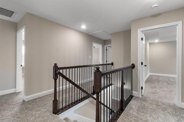 corridor featuring light colored carpet