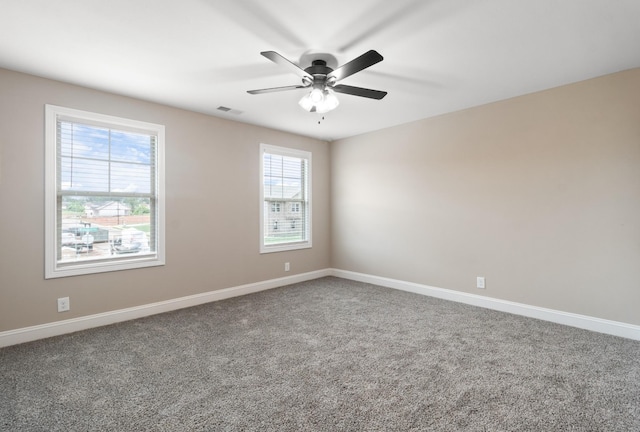 empty room featuring ceiling fan and carpet floors