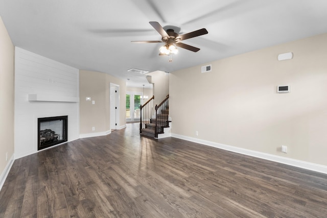 unfurnished living room featuring ceiling fan, a fireplace, and dark hardwood / wood-style floors