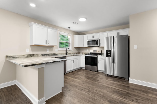 kitchen featuring appliances with stainless steel finishes, white cabinets, hanging light fixtures, light stone counters, and kitchen peninsula