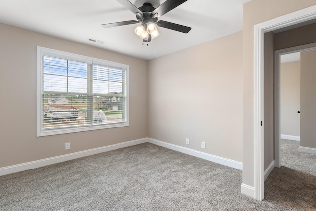 unfurnished room featuring light colored carpet and ceiling fan