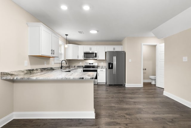 kitchen with white cabinetry, decorative light fixtures, kitchen peninsula, and appliances with stainless steel finishes