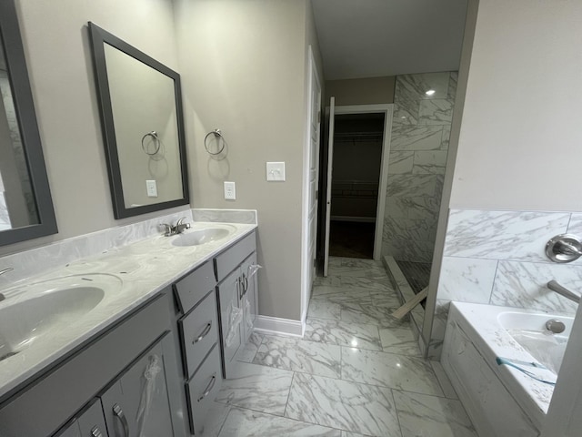 bathroom featuring a tub to relax in and vanity