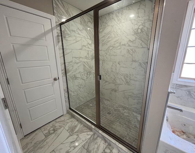 bathroom featuring separate shower and tub