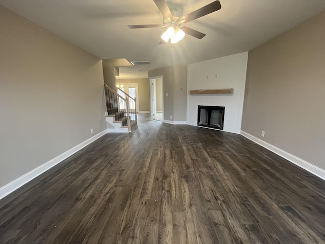 unfurnished living room with dark wood-type flooring and ceiling fan